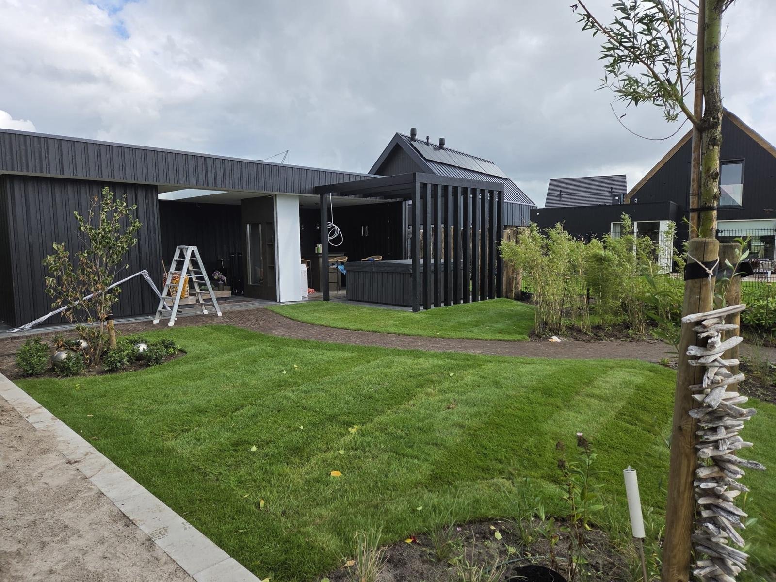 Gazon, gebakken waaltjes en terras bij de moderne woning
